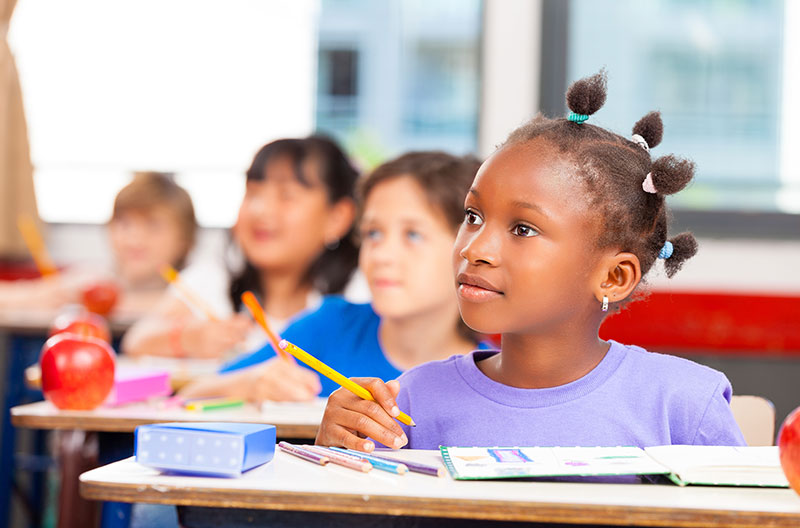 Young girl in school listening